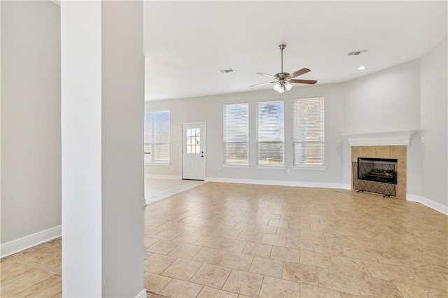 unfurnished living room with a fireplace and ceiling fan