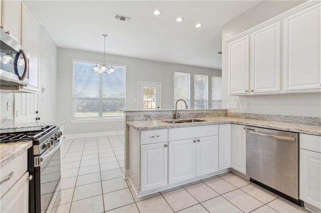 kitchen featuring stainless steel appliances, white cabinetry, and sink