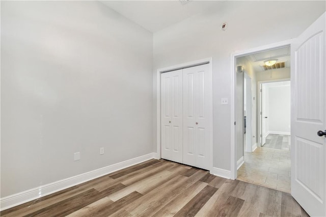 bedroom featuring light wood-type flooring and a closet