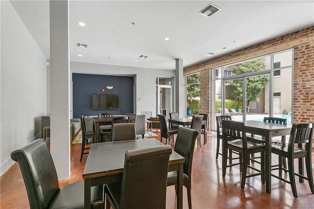 dining space featuring concrete floors