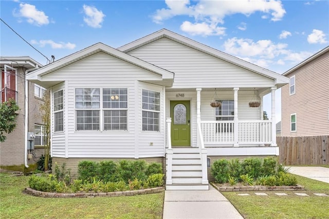 bungalow-style home with covered porch and a front lawn