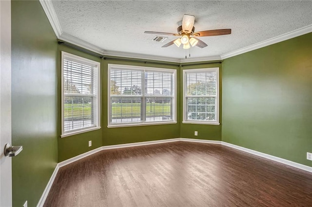 empty room featuring hardwood / wood-style flooring, plenty of natural light, crown molding, and a textured ceiling