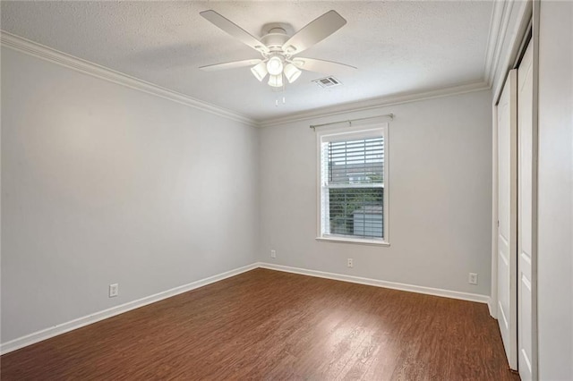 unfurnished bedroom featuring ceiling fan, dark hardwood / wood-style flooring, and crown molding