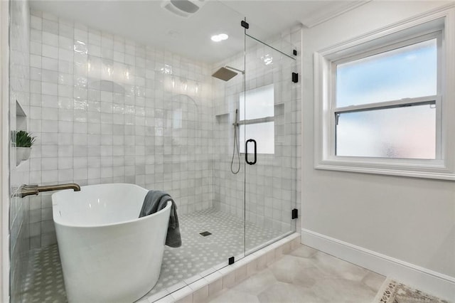 bathroom with separate shower and tub and tile patterned flooring