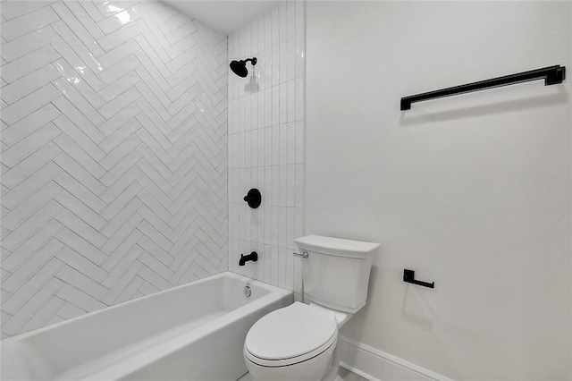 bathroom with tiled shower / bath combo and toilet