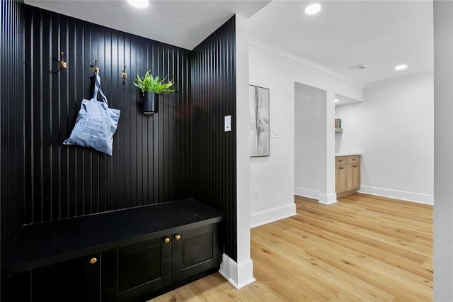 mudroom with wood-type flooring and ornamental molding