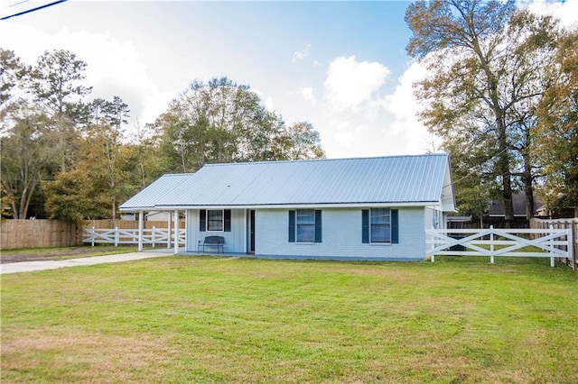 view of front of home with a front lawn and a carport