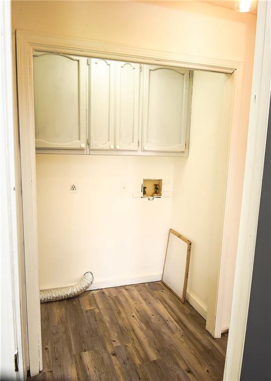 laundry area featuring cabinets, washer hookup, and dark hardwood / wood-style floors