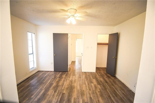 unfurnished bedroom with a textured ceiling, ceiling fan, and dark hardwood / wood-style floors