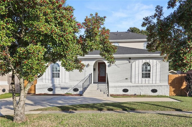 obstructed view of property with a front lawn