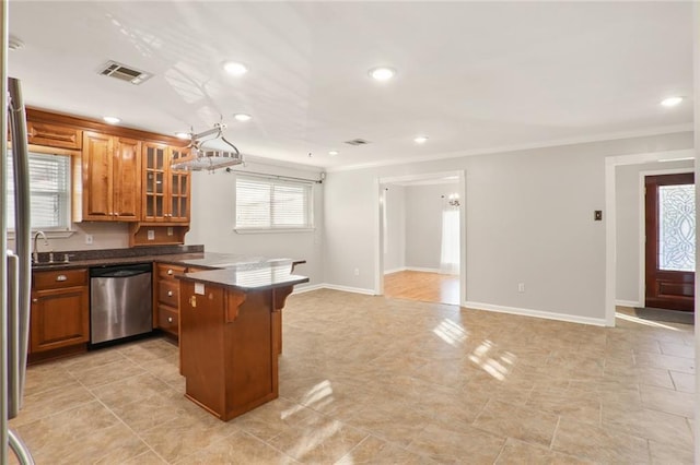 kitchen with a kitchen breakfast bar, sink, crown molding, stainless steel dishwasher, and kitchen peninsula