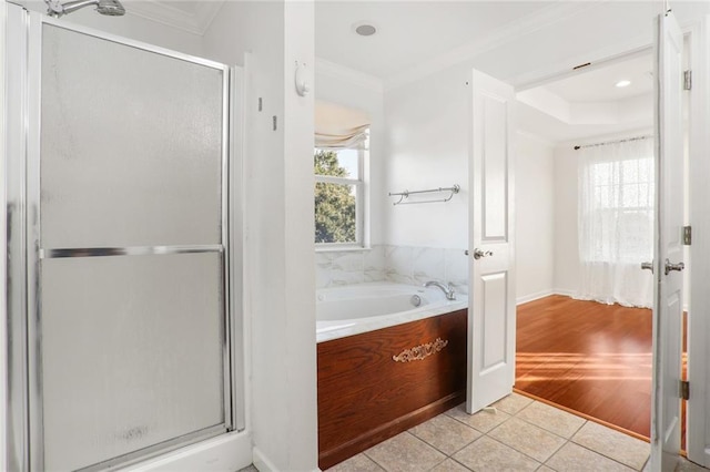 bathroom featuring separate shower and tub, hardwood / wood-style floors, and ornamental molding