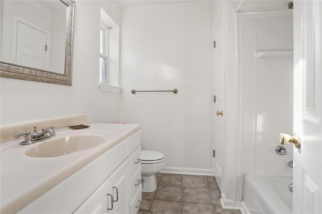 bathroom featuring tile patterned flooring, vanity, and toilet