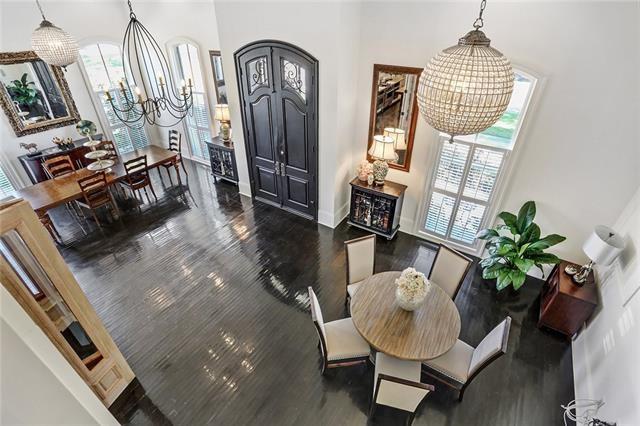 interior space featuring dark hardwood / wood-style flooring, a towering ceiling, and an inviting chandelier