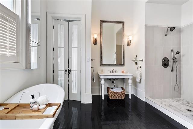 bathroom with plus walk in shower and hardwood / wood-style flooring