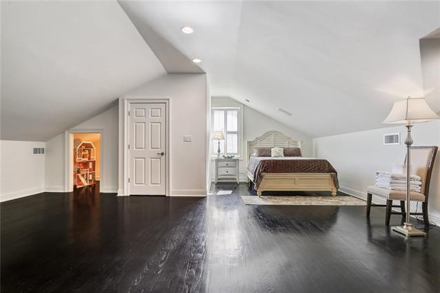 bedroom with dark hardwood / wood-style floors and lofted ceiling