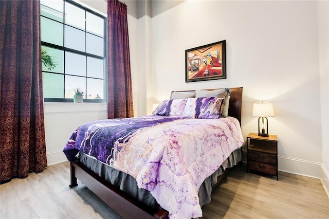 bedroom featuring multiple windows and light wood-type flooring