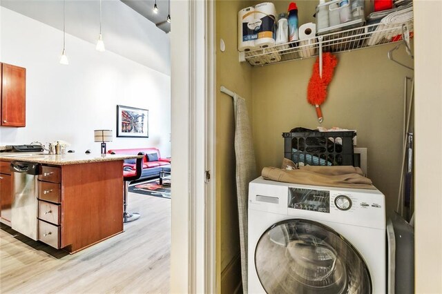 1201 Canal St Unit 271, New Orleans, LA 70112 - laundry area featuring washer / clothes dryer and light wood-style flooring