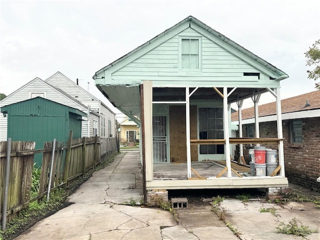 rear view of property featuring a sunroom