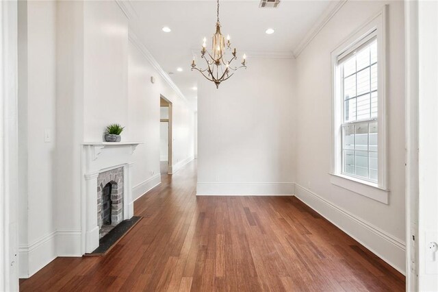 1805 Governor Nicholls St, New Orleans, LA 70116 - unfurnished living room featuring hardwood / wood-style flooring, a chandelier, ornamental molding, recessed lighting, and a fireplace