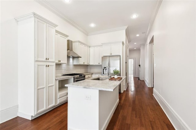 1805 Governor Nicholls St, New Orleans, LA 70116 - kitchen with wall chimney range hood, stainless steel appliances, dark wood-style flooring, a kitchen island with sink, and crown molding