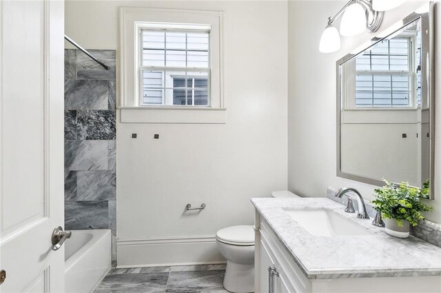 1805 Governor Nicholls St, New Orleans, LA 70116 - full bath with vanity, healthy amount of natural light, shower / tub combination, and marble look tiles