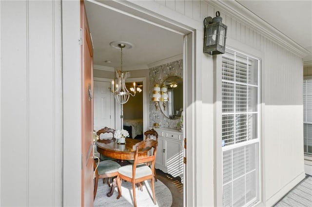 exterior space with a notable chandelier and ornamental molding