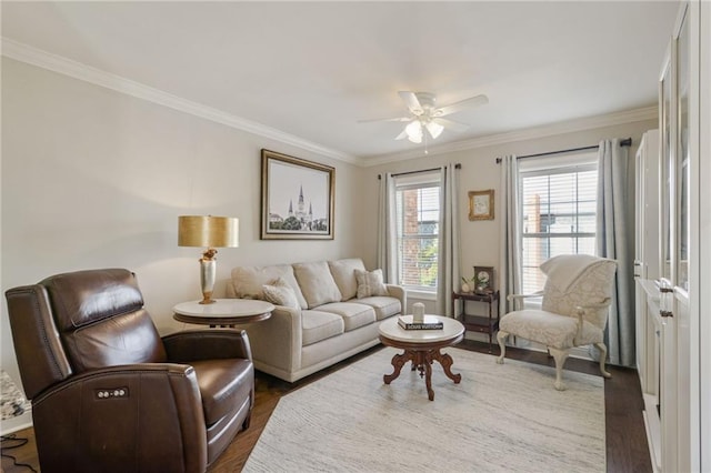 living room with dark hardwood / wood-style flooring, ceiling fan, and crown molding