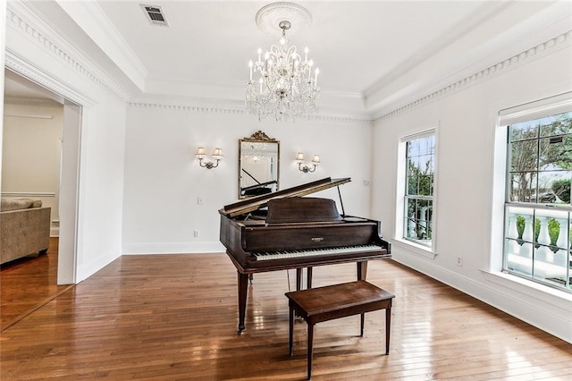 miscellaneous room with hardwood / wood-style flooring and a notable chandelier