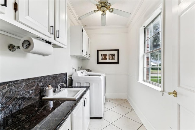 laundry area with sink, washing machine and clothes dryer, cabinets, ceiling fan, and light tile patterned floors