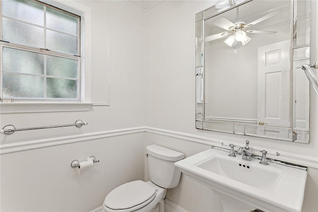 bathroom featuring sink, ceiling fan, a healthy amount of sunlight, and toilet