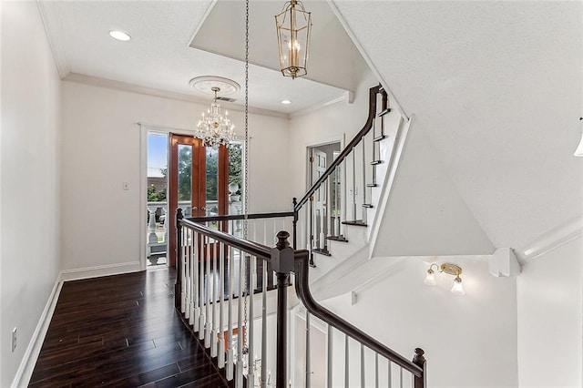 staircase with hardwood / wood-style flooring, an inviting chandelier, french doors, and ornamental molding