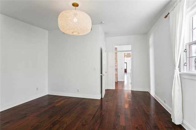 spare room with dark wood-type flooring