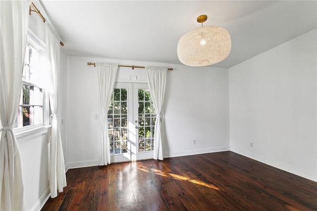 empty room with french doors and dark hardwood / wood-style floors