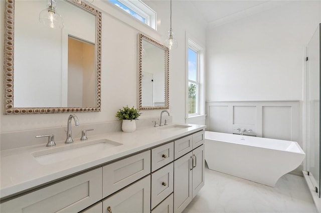 bathroom with crown molding, a bathtub, and vanity