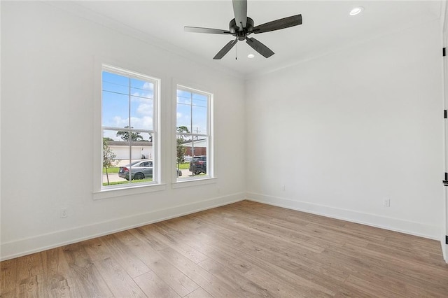 spare room featuring light hardwood / wood-style floors, ceiling fan, and crown molding