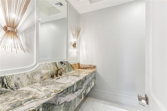 bathroom featuring vanity and tasteful backsplash