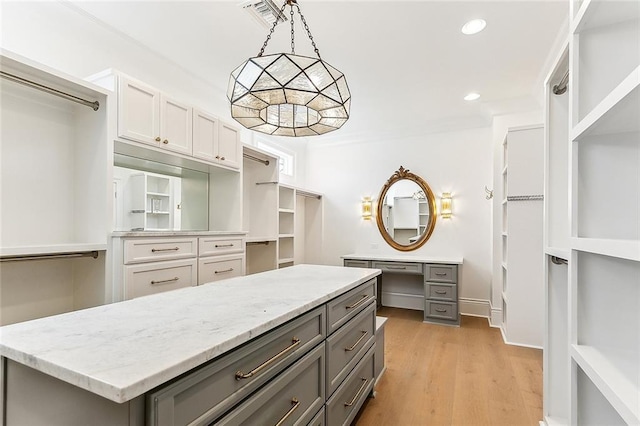 spacious closet with light hardwood / wood-style flooring