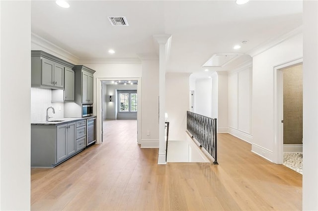 kitchen with light hardwood / wood-style floors, beverage cooler, gray cabinetry, and sink