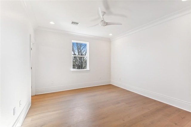 spare room with ceiling fan, light wood-type flooring, and crown molding