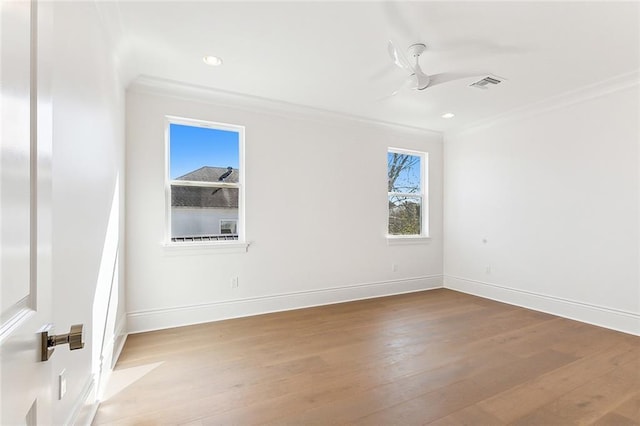 empty room with crown molding and wood-type flooring