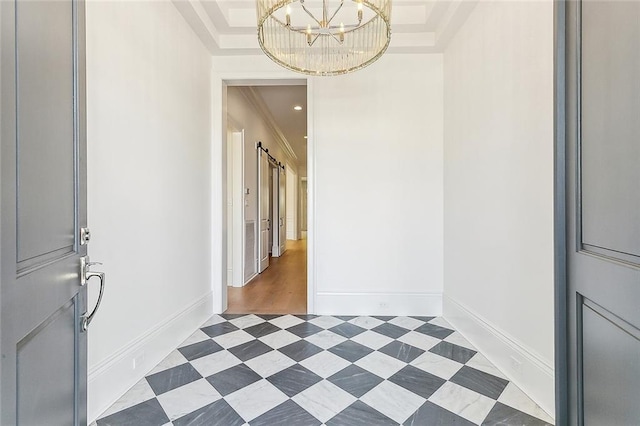 foyer entrance with a notable chandelier, dark hardwood / wood-style floors, a raised ceiling, and crown molding