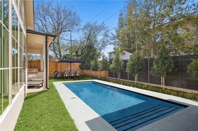 view of swimming pool featuring a yard and a patio area