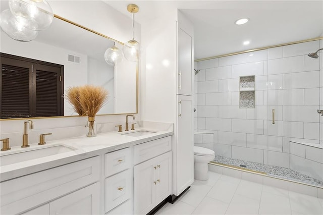 bathroom featuring walk in shower, tile patterned floors, vanity, and toilet