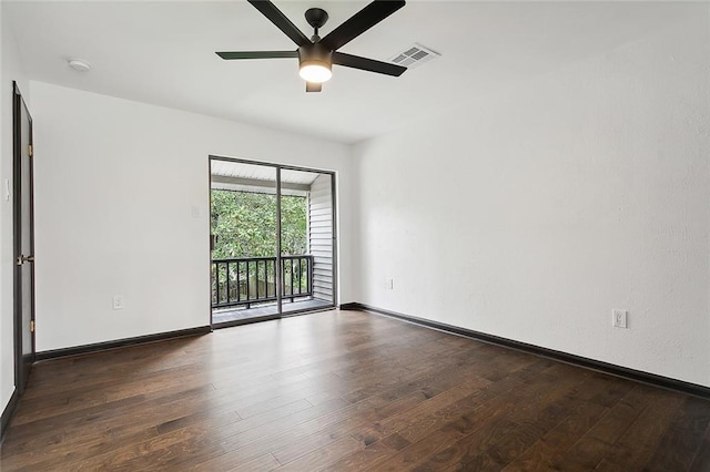 spare room featuring dark hardwood / wood-style floors and ceiling fan