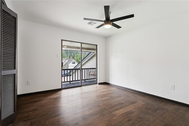 spare room with ceiling fan and dark wood-type flooring