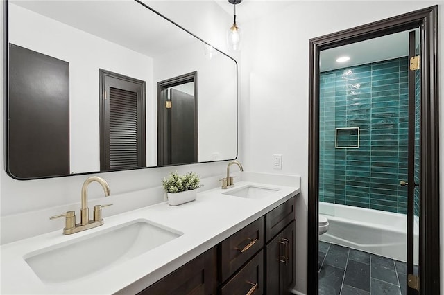 full bathroom featuring vanity, toilet, and tiled shower / bath combo