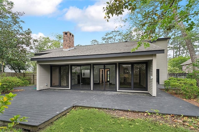 rear view of property featuring a deck