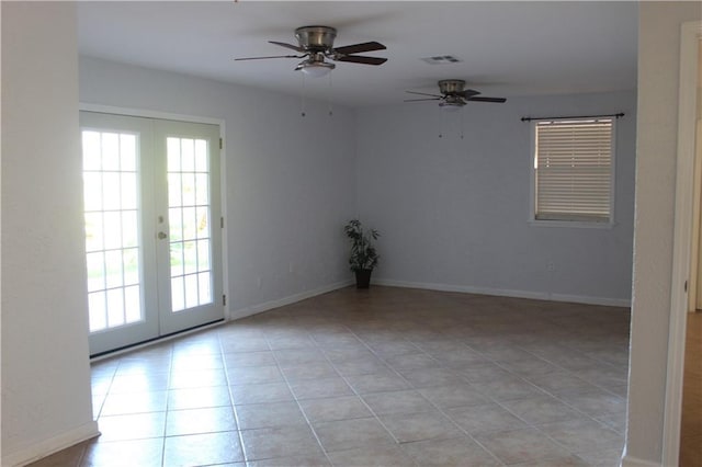 spare room with french doors, ceiling fan, and light tile patterned flooring