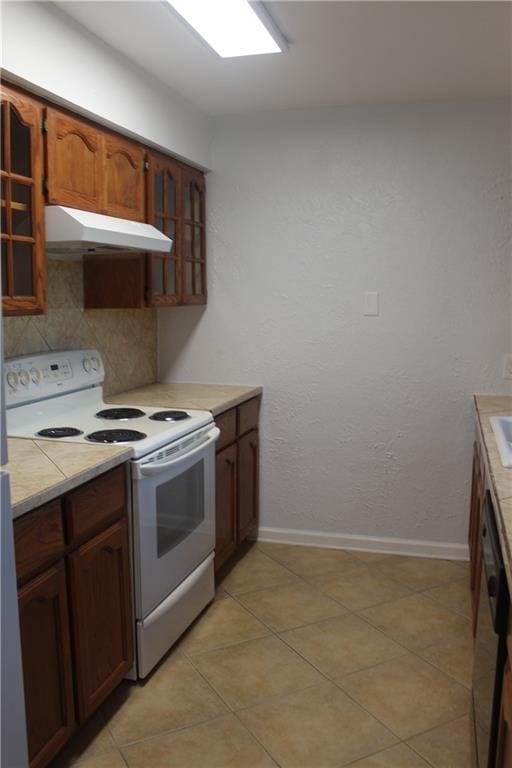 kitchen featuring white electric range, black dishwasher, light tile patterned floors, and tasteful backsplash